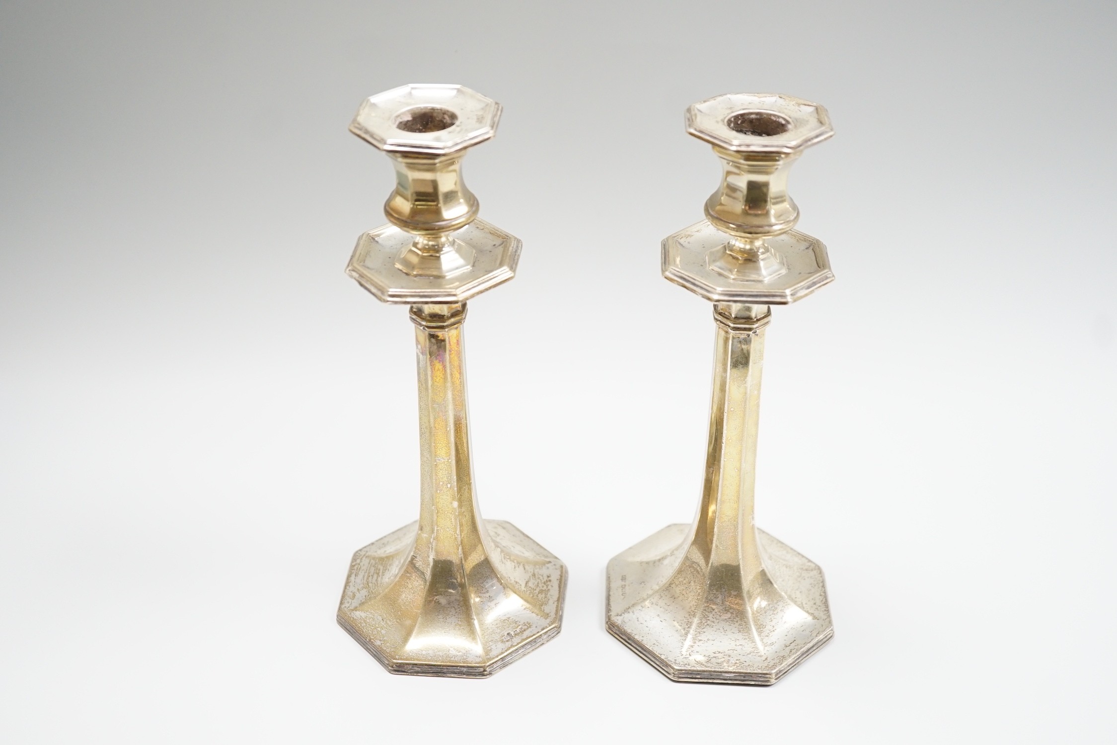 A pair of George V silver mounted candlesticks, with panelled stems, by James Dixon & Sons, Sheffield, 1913, height 21.8cm, weighted.